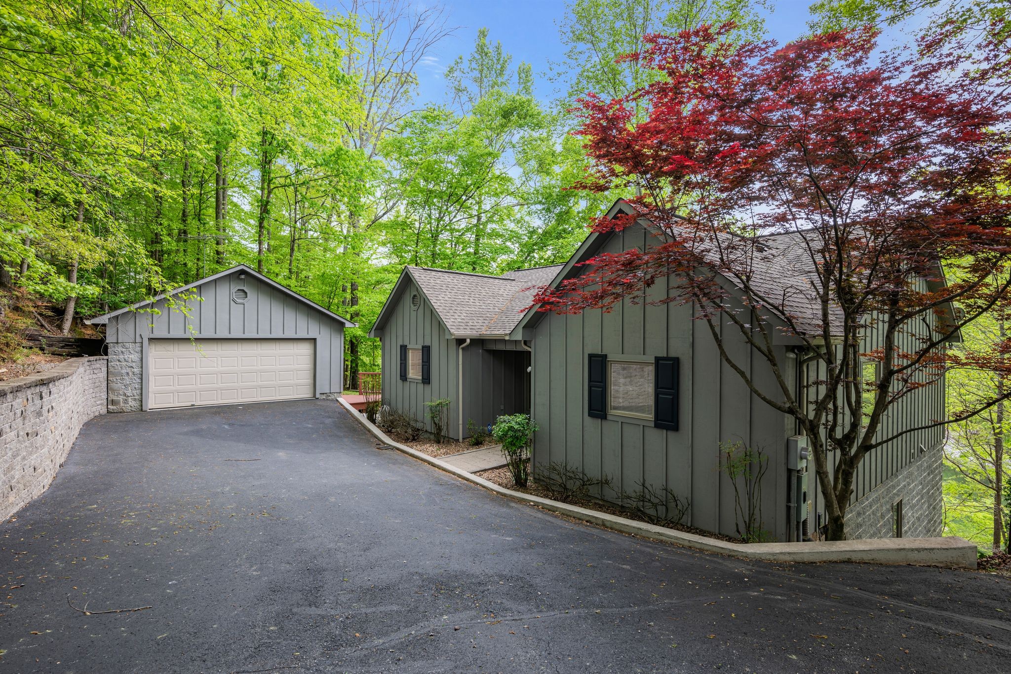 front view of house with a yard and trees