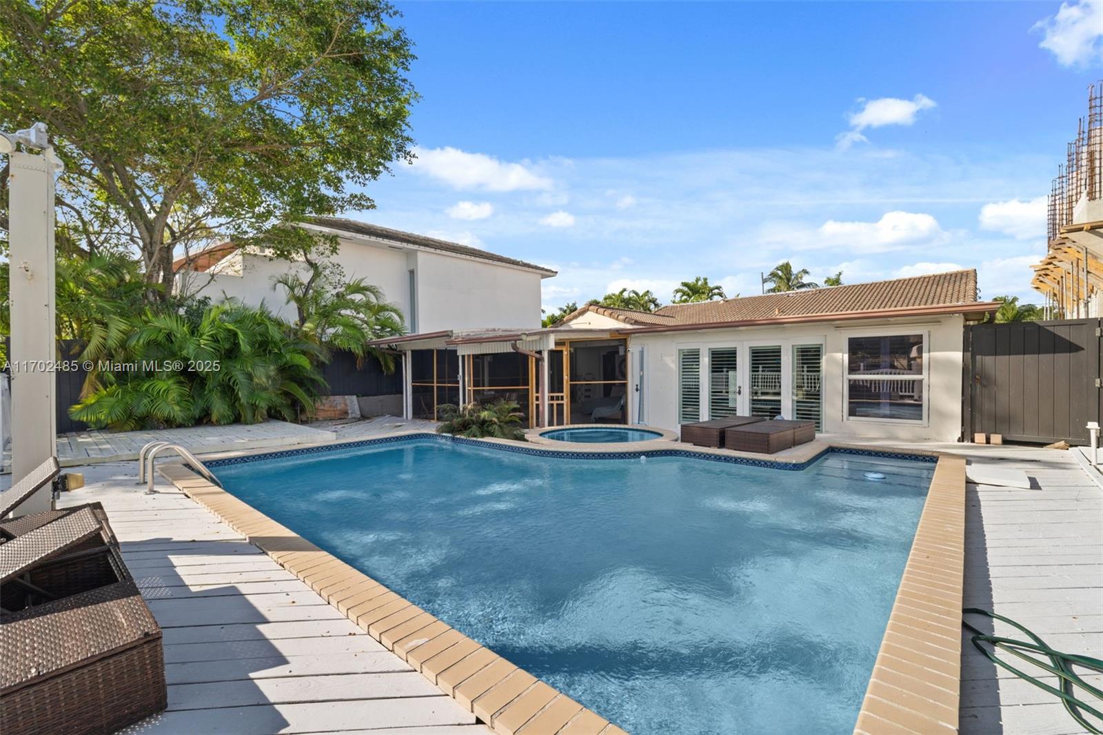 a view of a house with swimming pool and sitting area