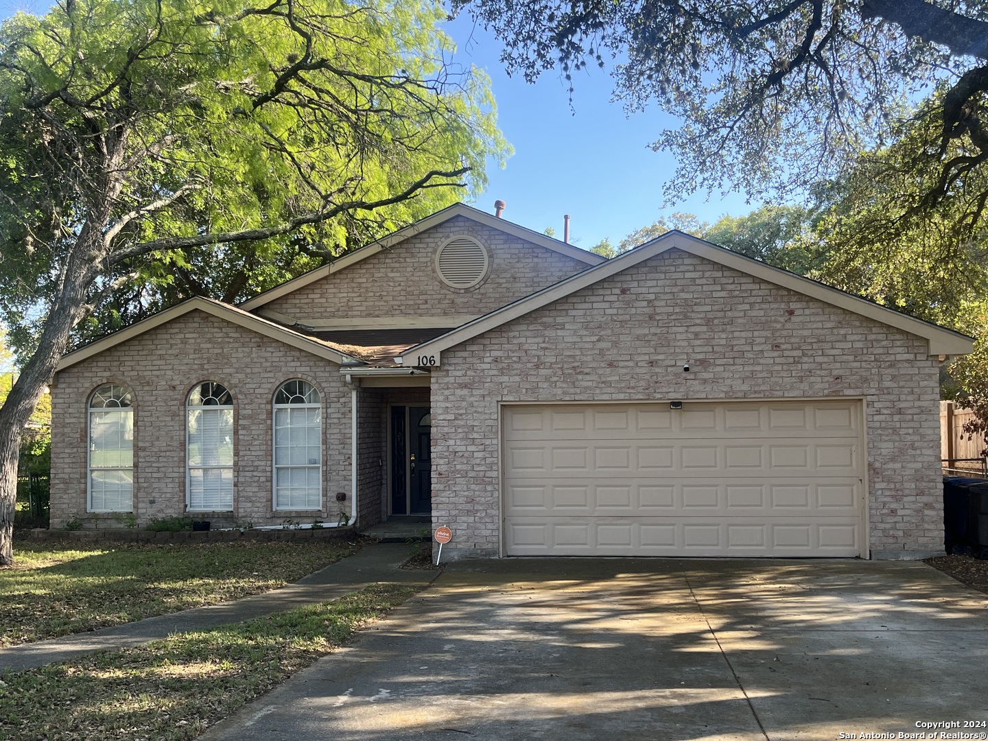 a view of a house with a yard and garage