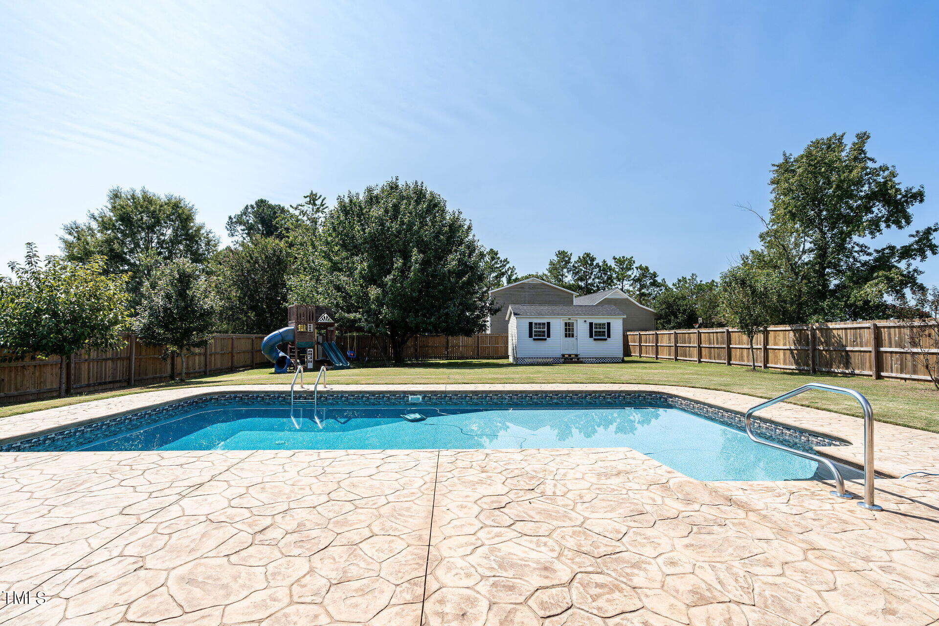 a view of a swimming pool with an outdoor seating