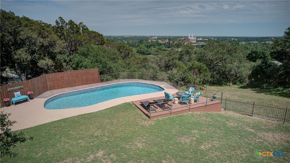 swimming pool view with a outdoor seating