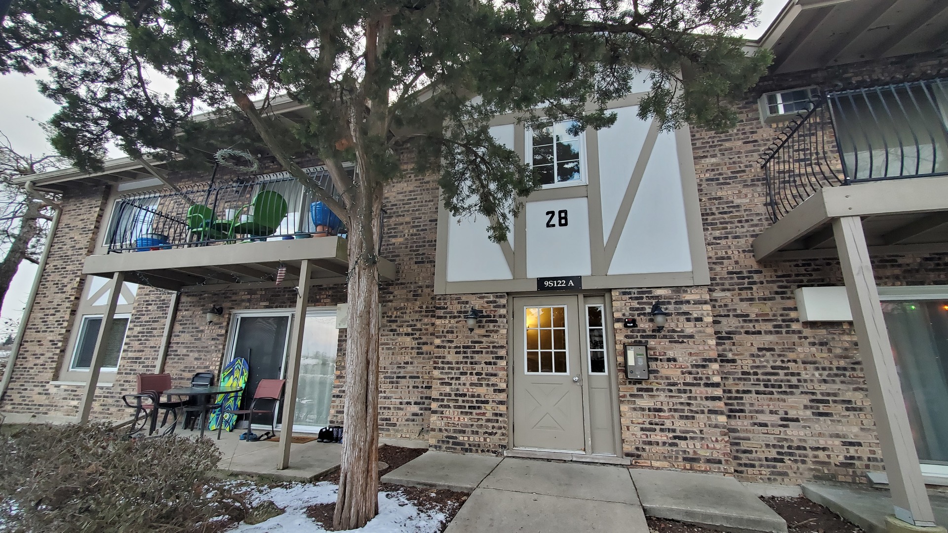 front view of a house with a tree