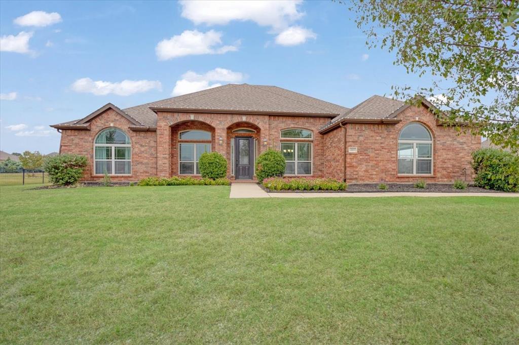 a front view of a house with a yard