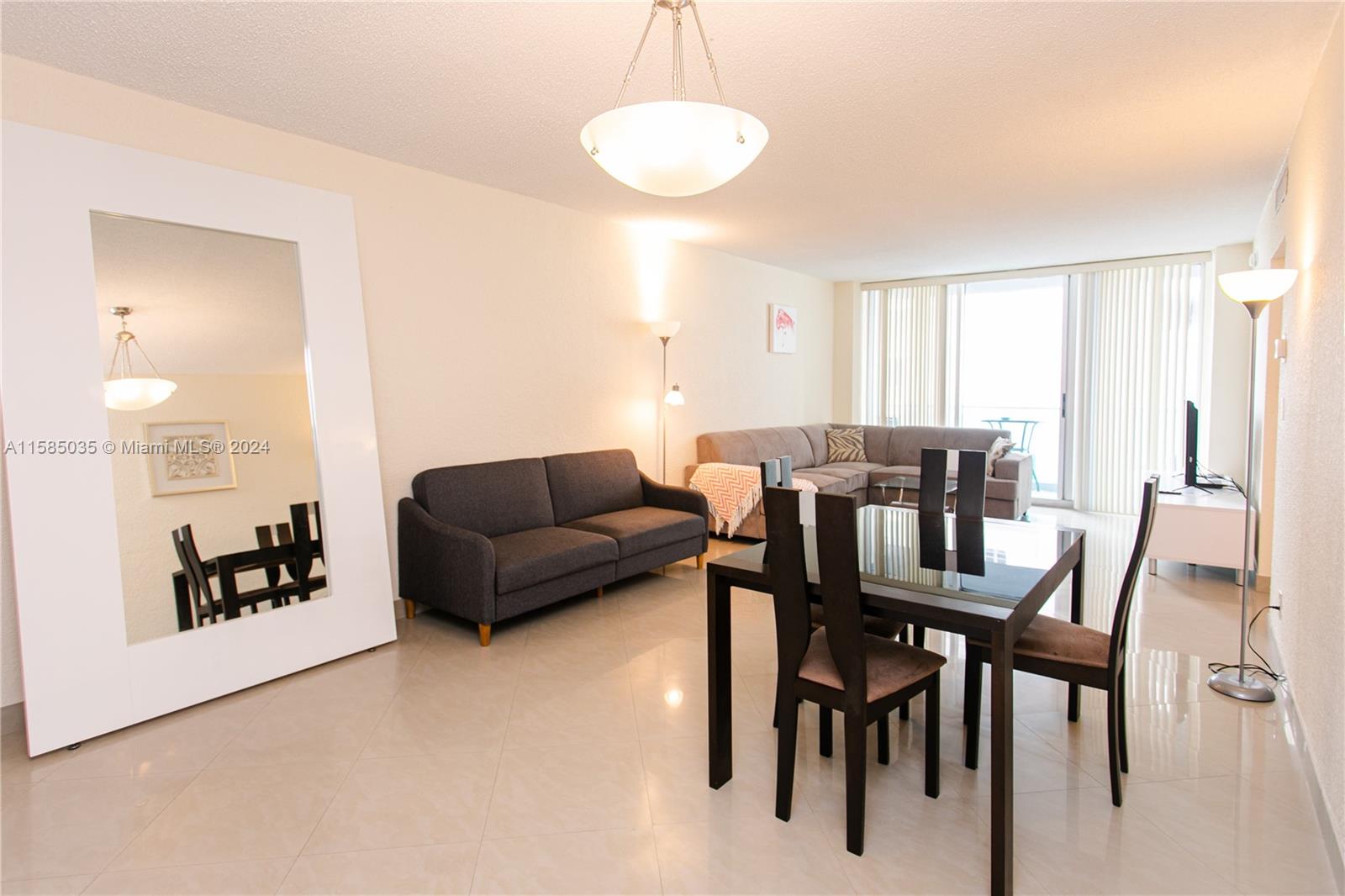 a living room with furniture a wooden floor and a chandelier