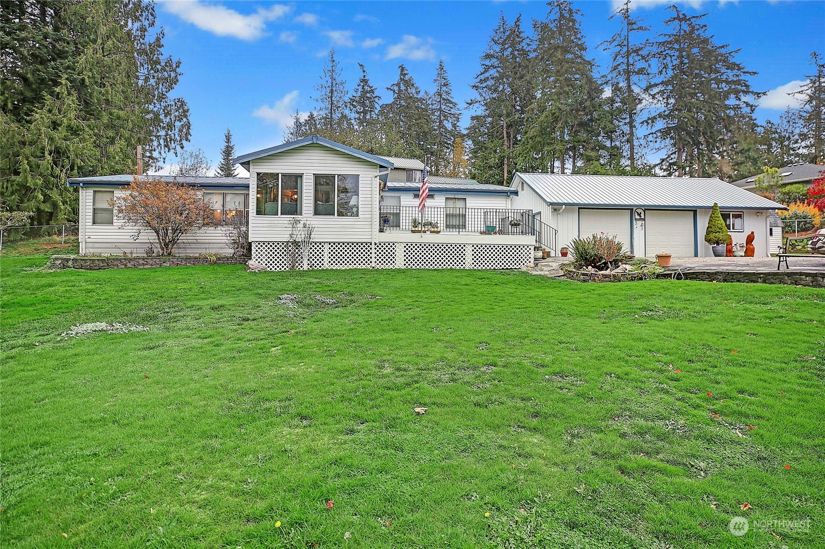 a view of a house with a big yard and large trees