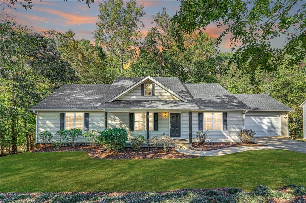 a front view of a house with a garden and patio