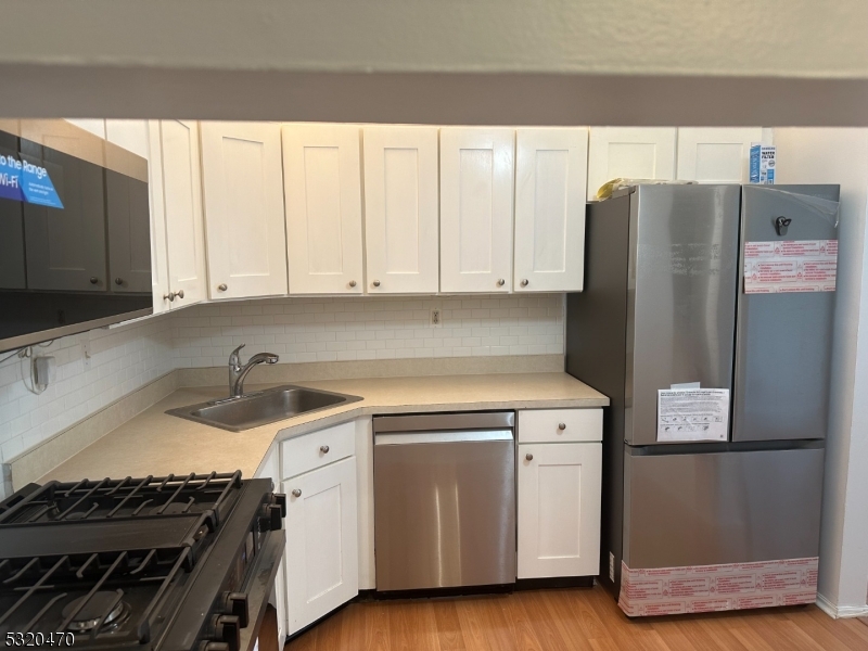 a kitchen with a sink stove and refrigerator