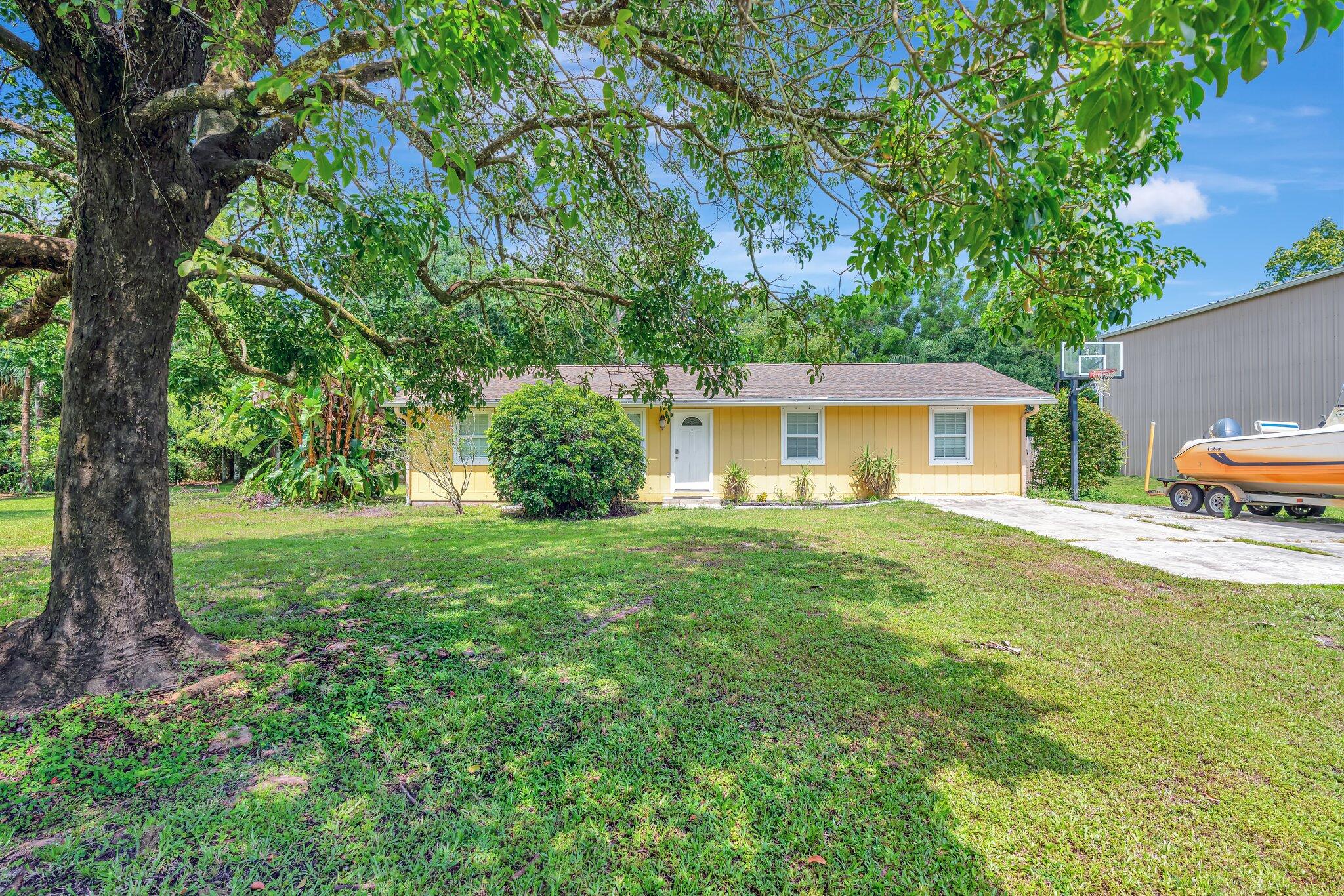 a front view of house with yard and green space