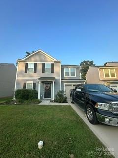 a car parked in front of a house with a yard