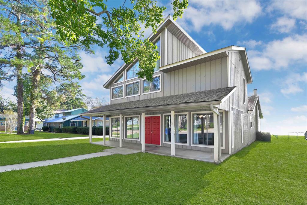 a view of house with yard and green space