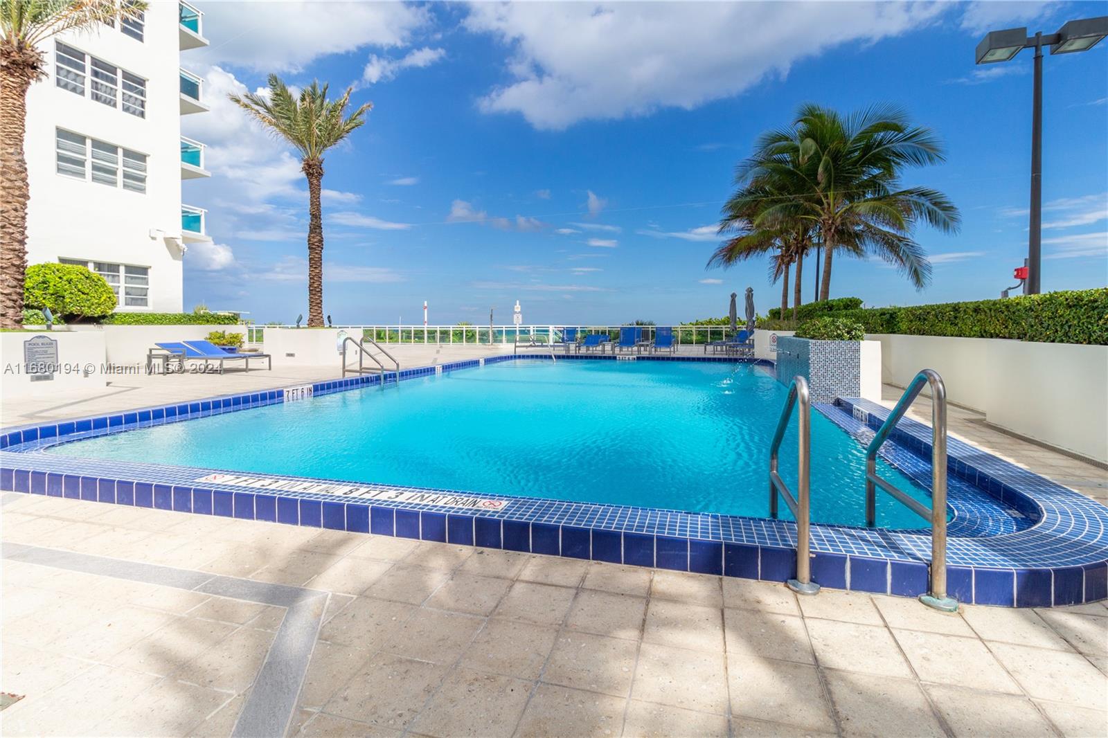 a view of swimming pool with a table and chairs