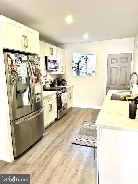 a kitchen with granite countertop stainless steel appliances and wooden cabinets