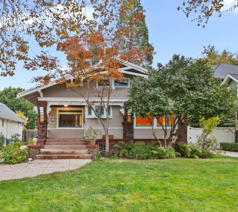 a front view of a house with a garden and plants