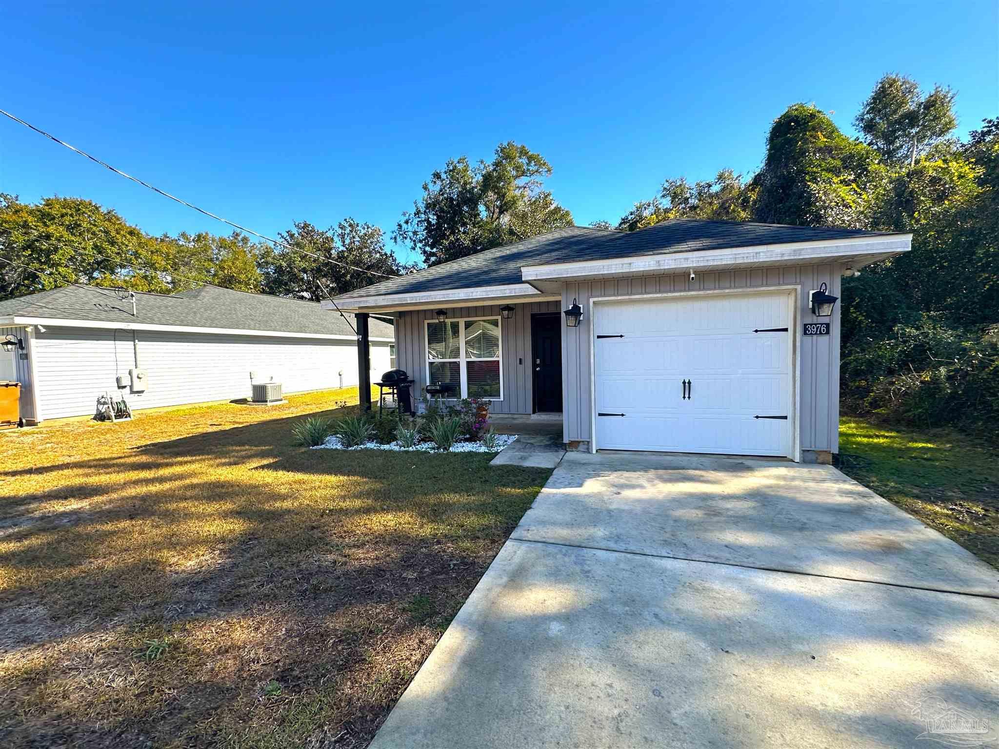 a view of a house with a yard and a garage