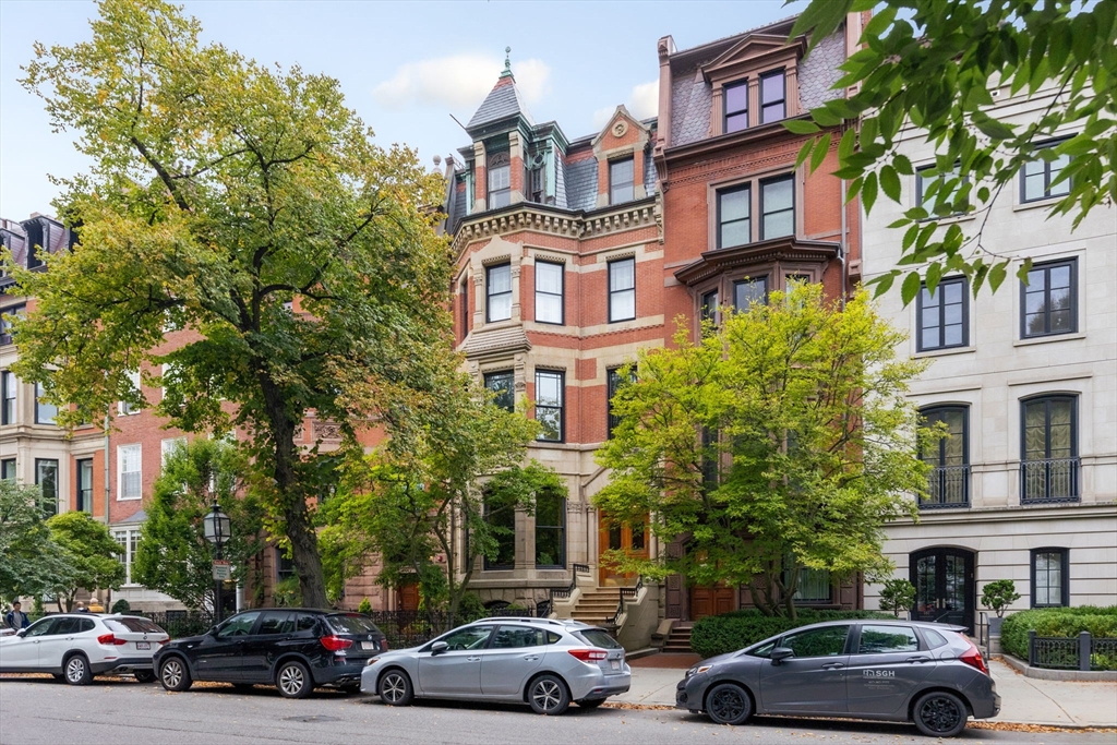 a view of a cars park in front of a building