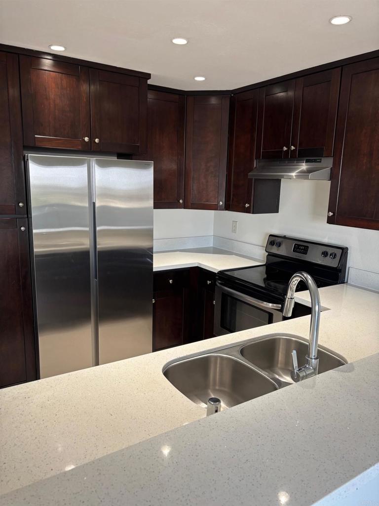 a kitchen with a sink and a refrigerator