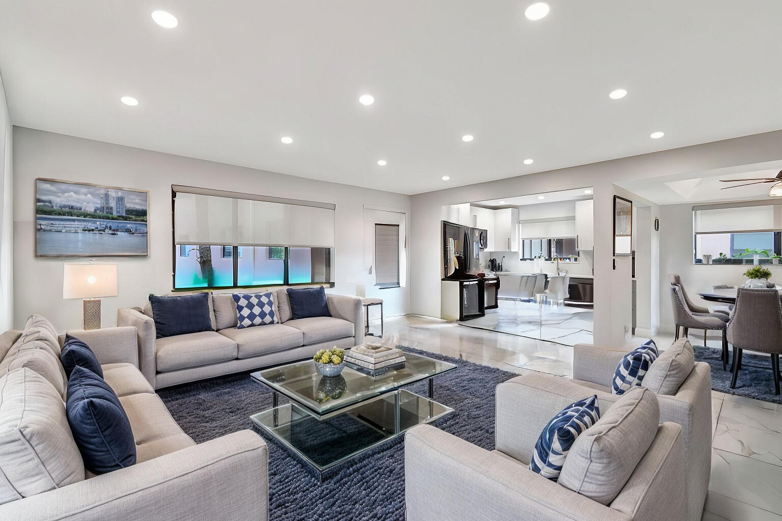 a living room with furniture and view of kitchen