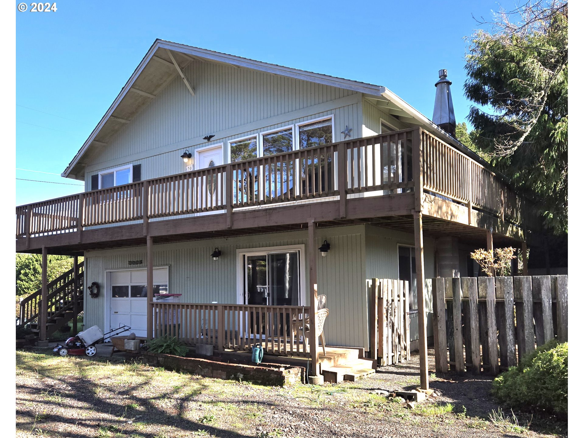 a view of a house with a patio and wooden fence