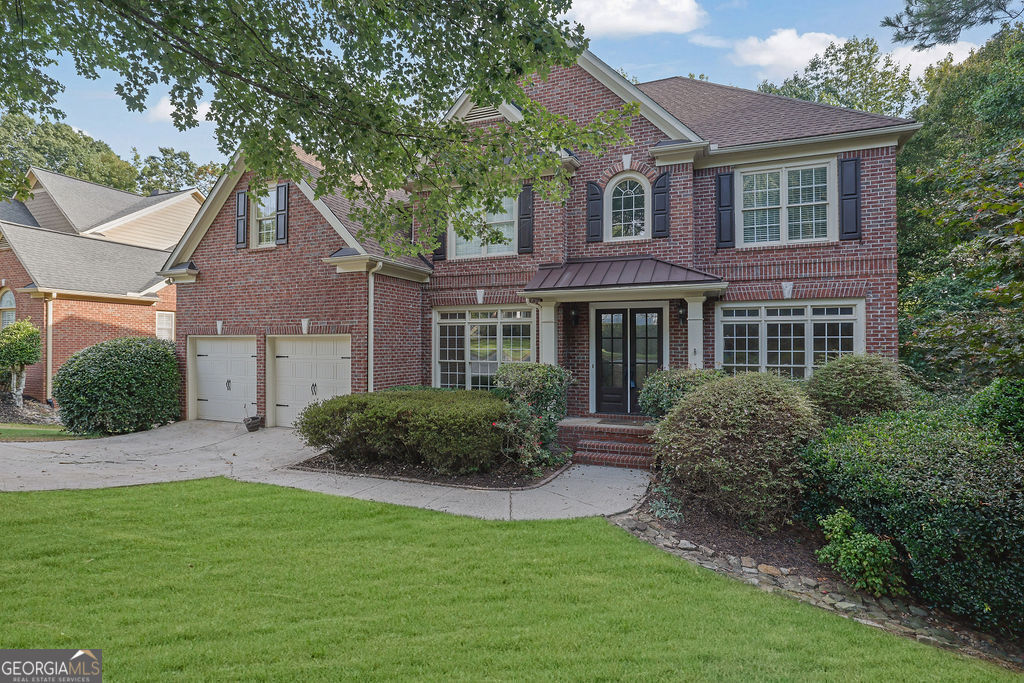 a front view of a house with a yard and porch