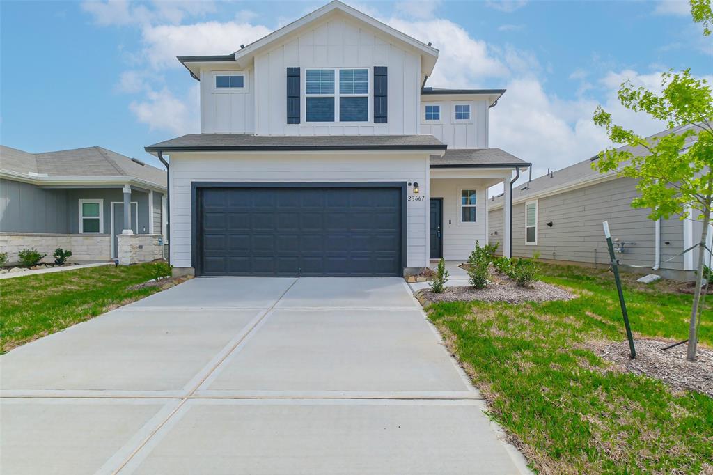 a front view of a house with a yard and garage