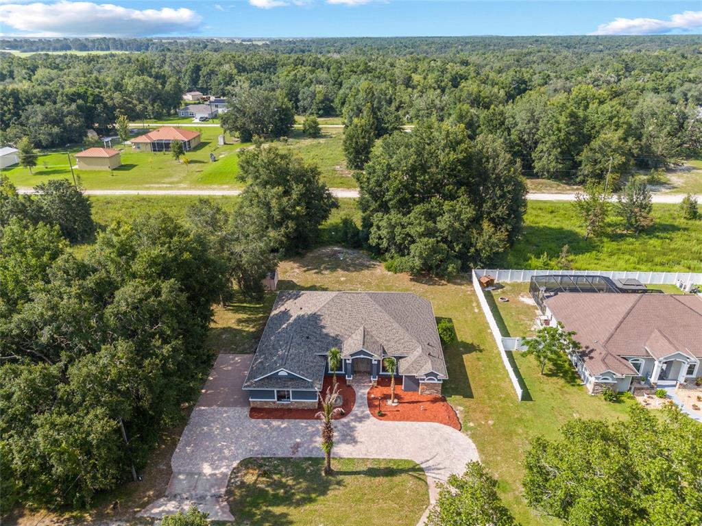 an aerial view of a house with outdoor space swimming pool and mountains