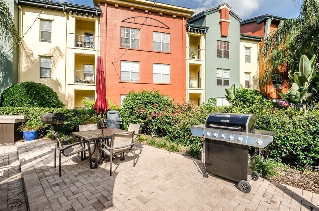 a view of a patio with table and chairs and potted plants