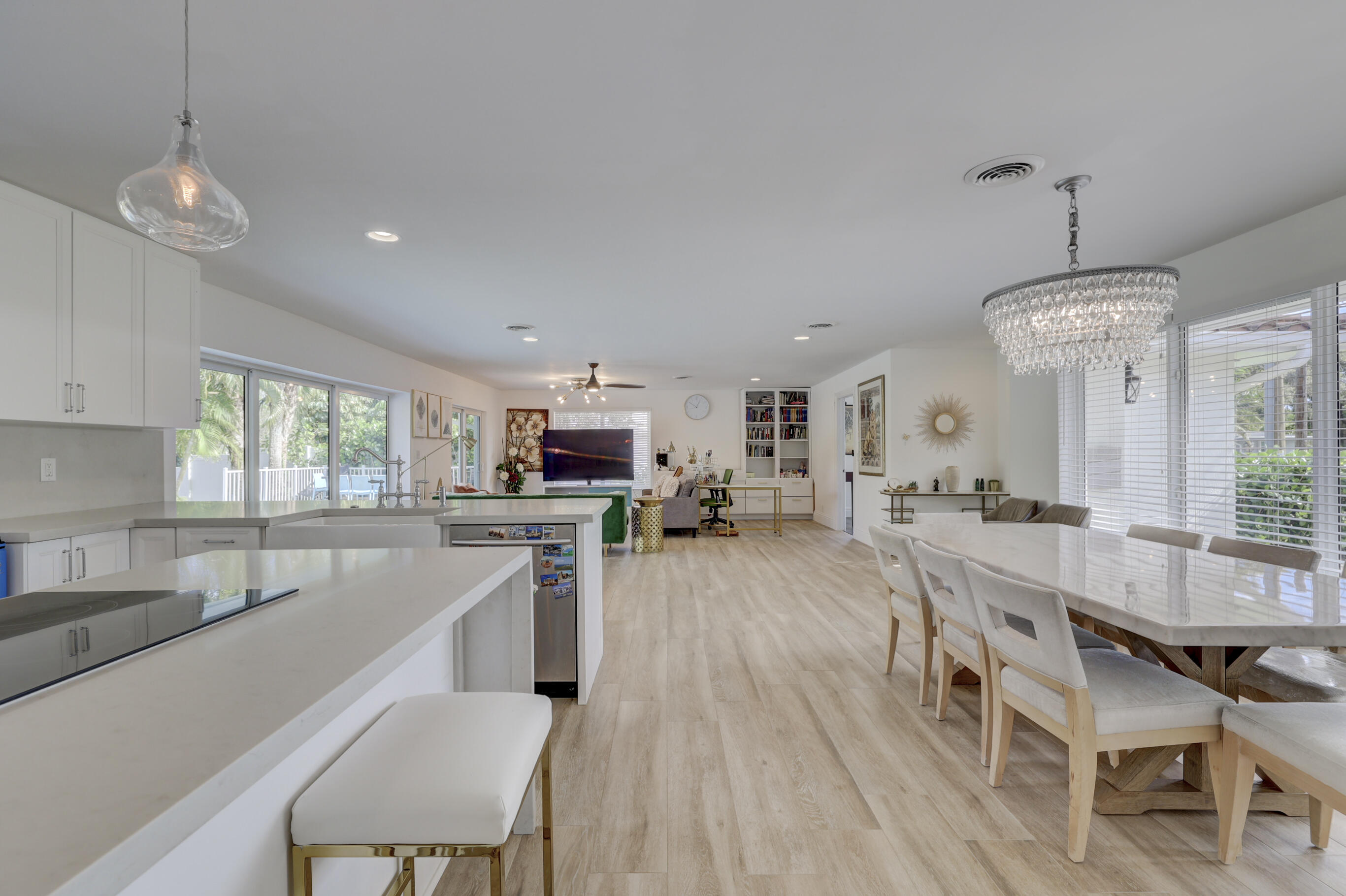 a large kitchen with kitchen island a large island in the center and stainless steel appliances