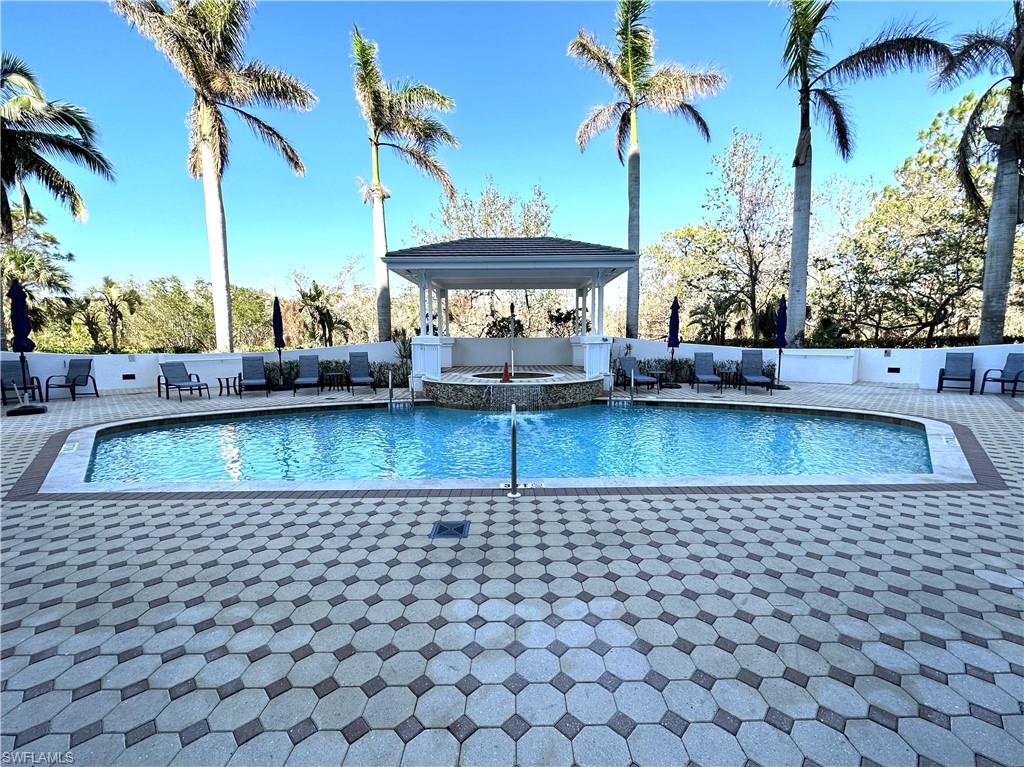 swimming pool view with a garden and trees