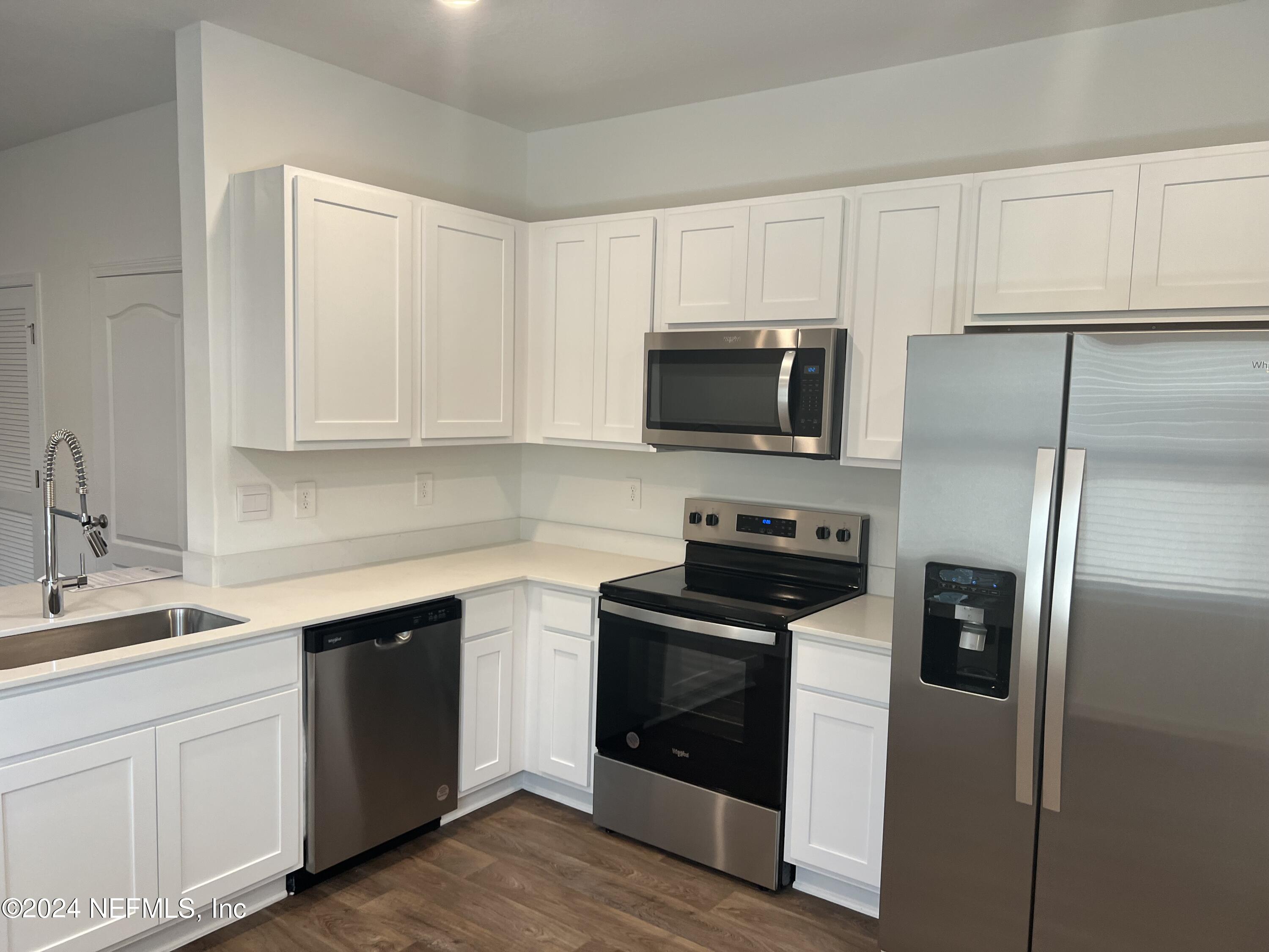 a kitchen with a refrigerator stove and microwave