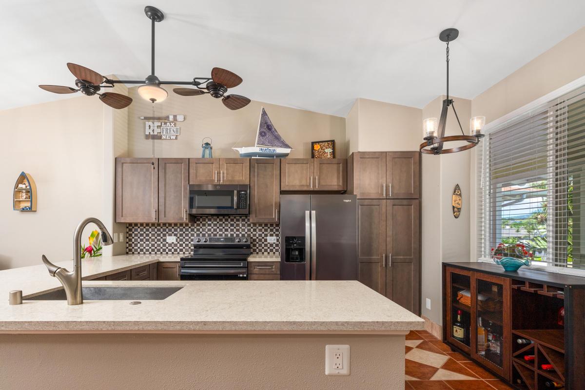 a kitchen view with a sink a stove and refrigerator