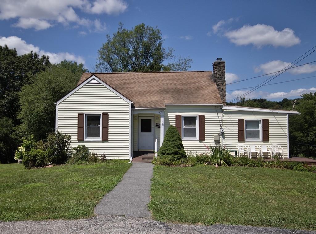 a front view of a house with a garden