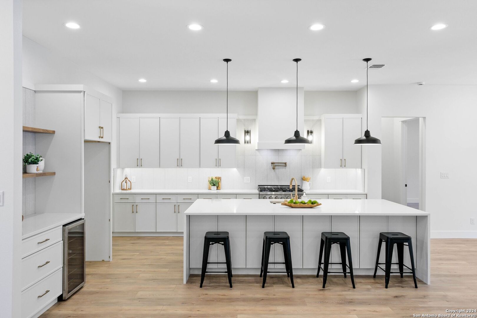 a kitchen with granite countertop cabinets and chairs