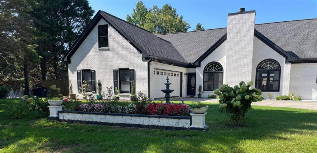 a front view of a house with a garden