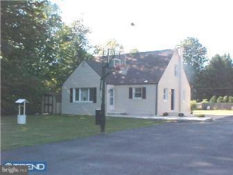 a view of a house with a yard and a garage