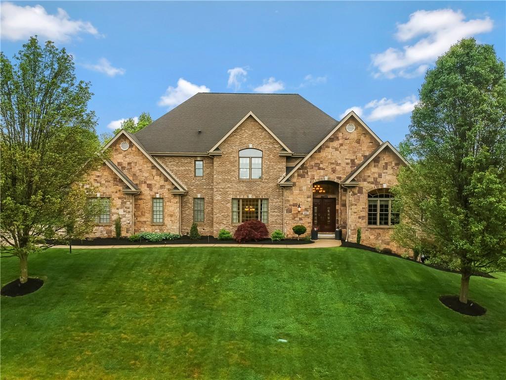 a front view of a house with a yard