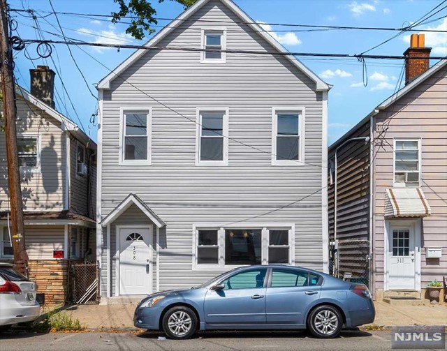 a front view of a house with parking space