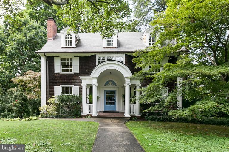 a view of a house with garden and trees