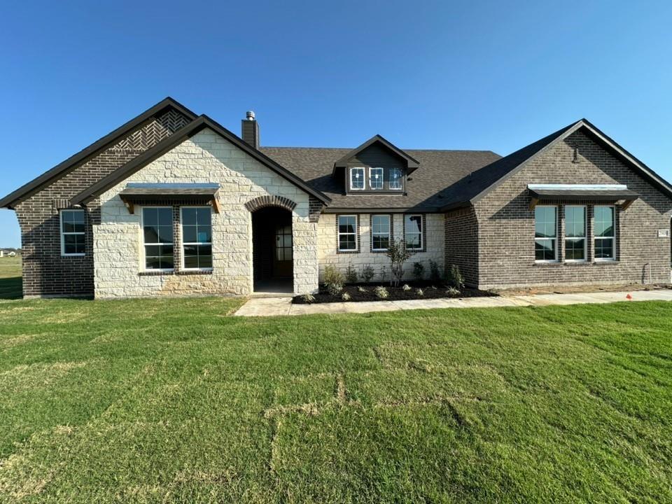 a front view of house with yard and green space