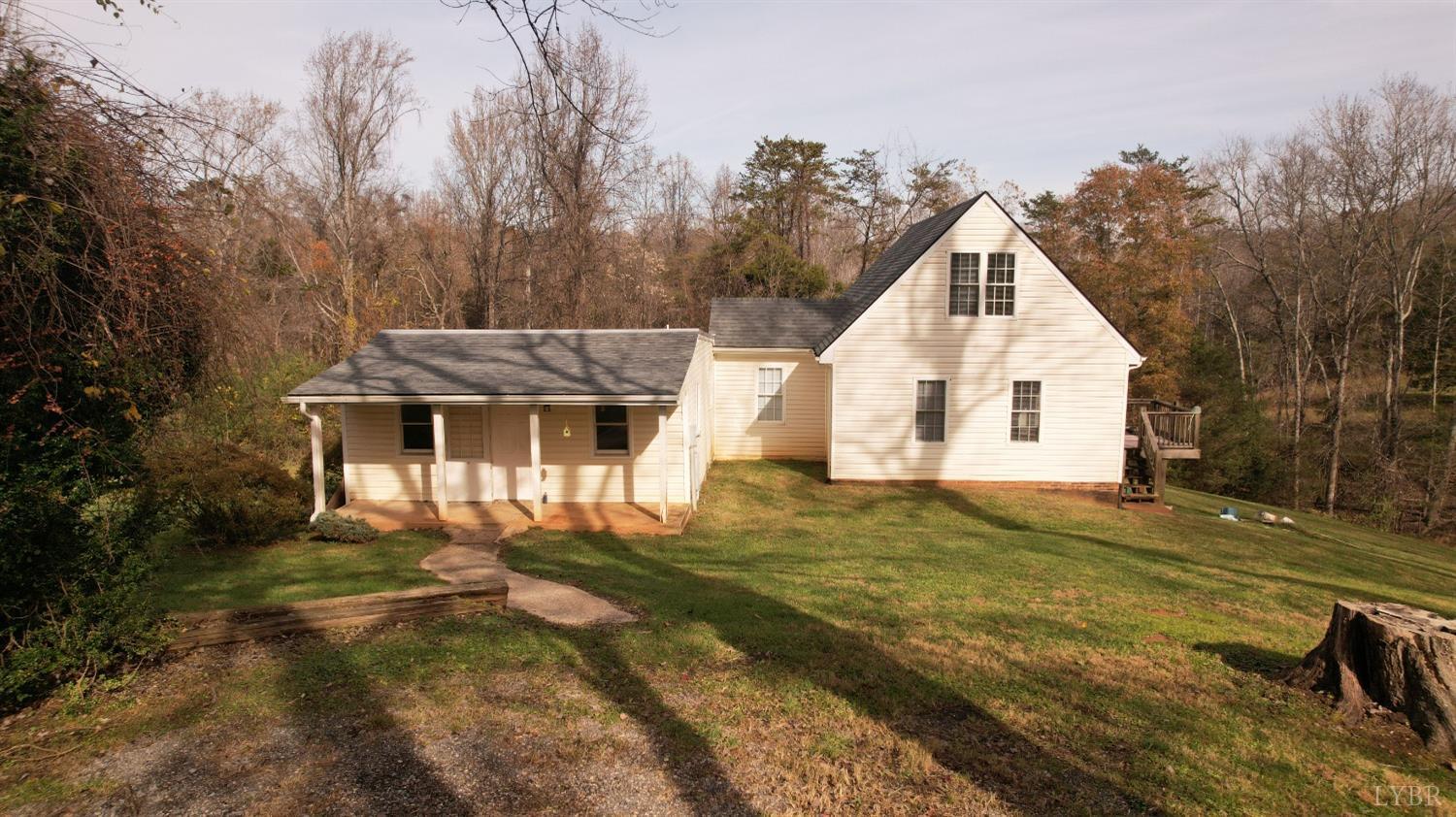 a view of a white house with a yard