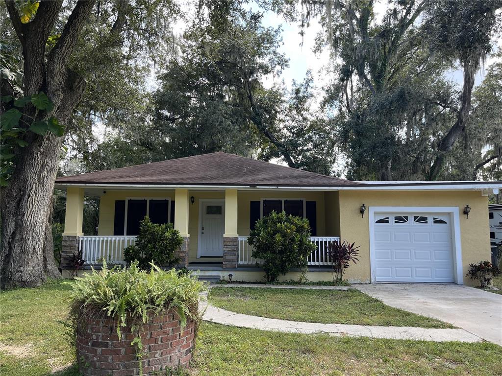 a front view of house with yard and trees