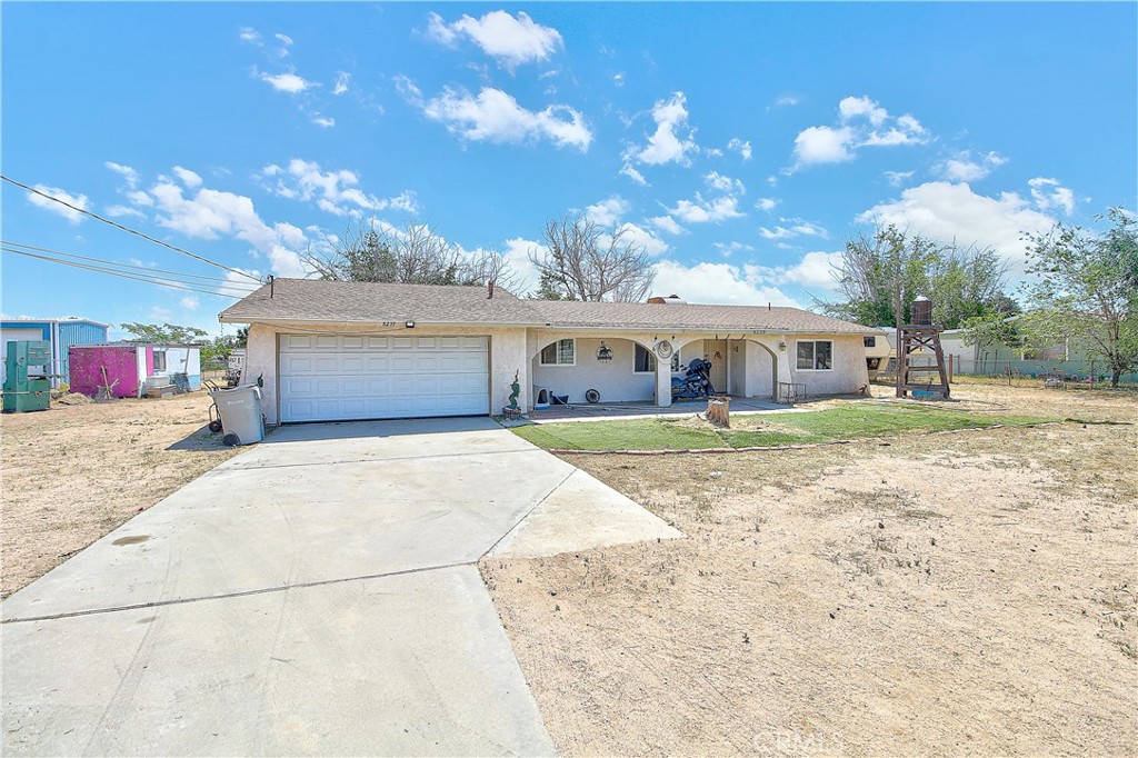 a house view with a swimming pool and a yard