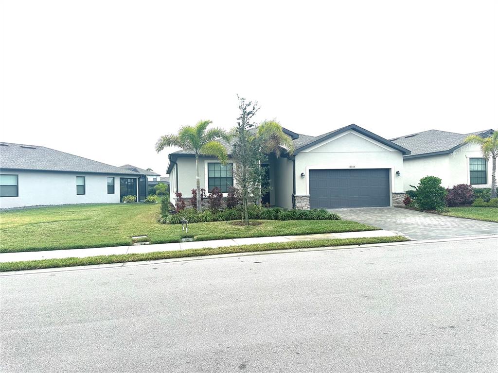 a front view of a house with a yard and garage