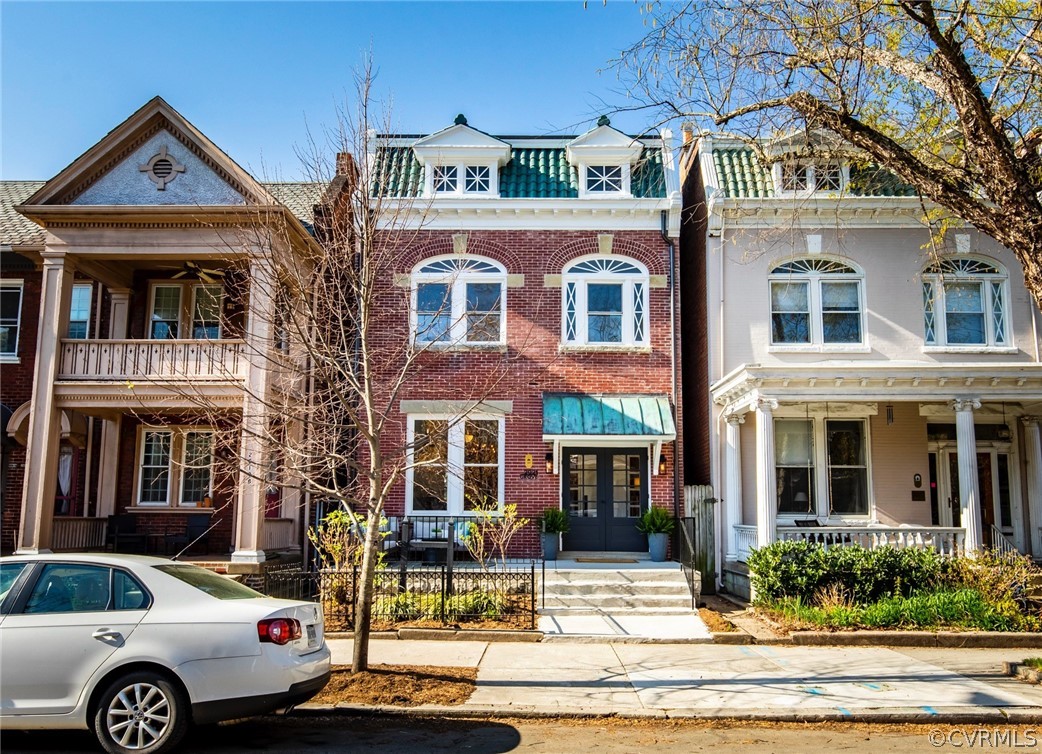 a front view of a residential apartment building with a yard