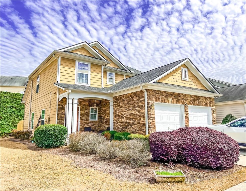 a front view of a house with garden