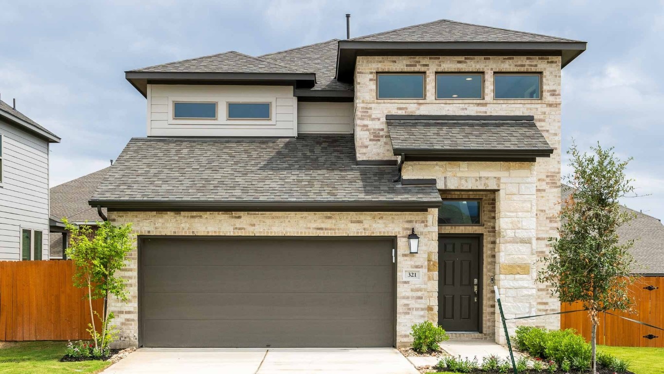 a front view of a house with a yard