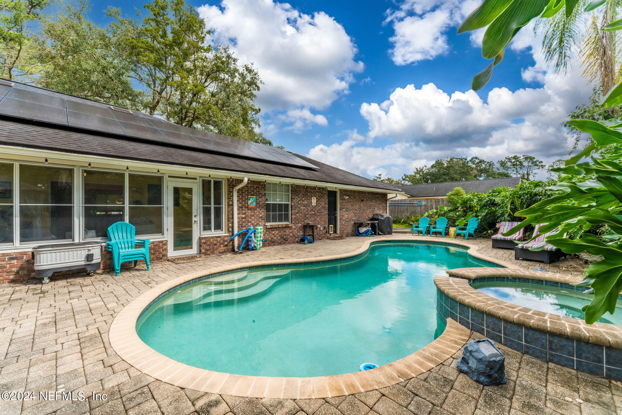 a view of a house with swimming pool and sitting area