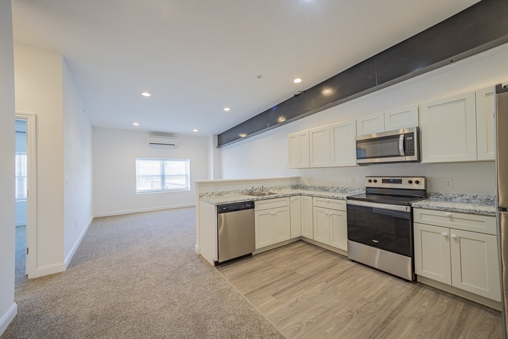 a large kitchen with a stove top oven and sink