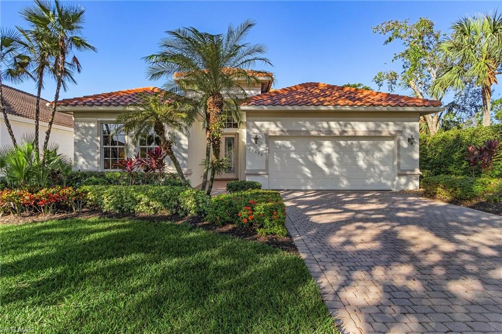 Mediterranean / spanish-style house featuring a front yard and a garage