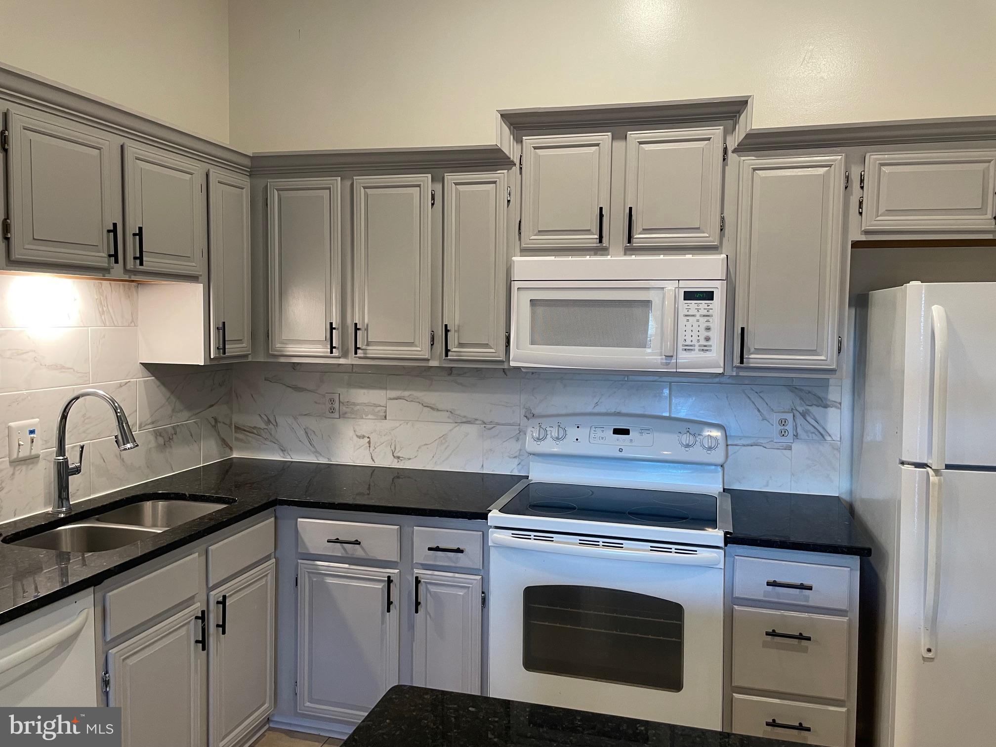 a kitchen with a sink stove and refrigerator