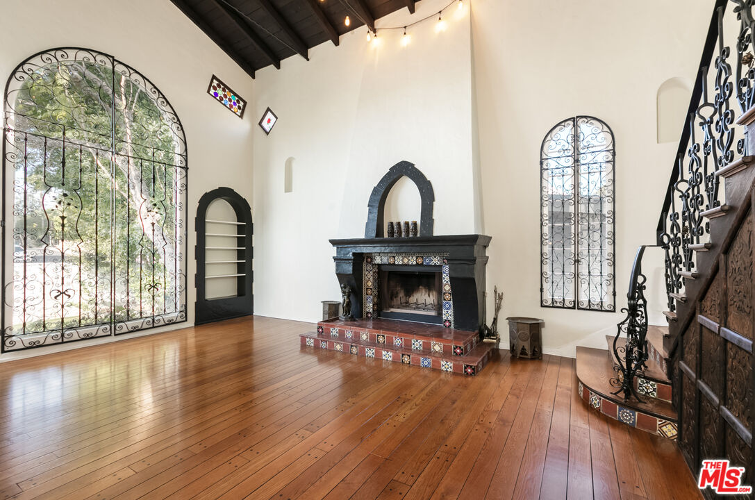 a living room with fireplace furniture and a wooden floor